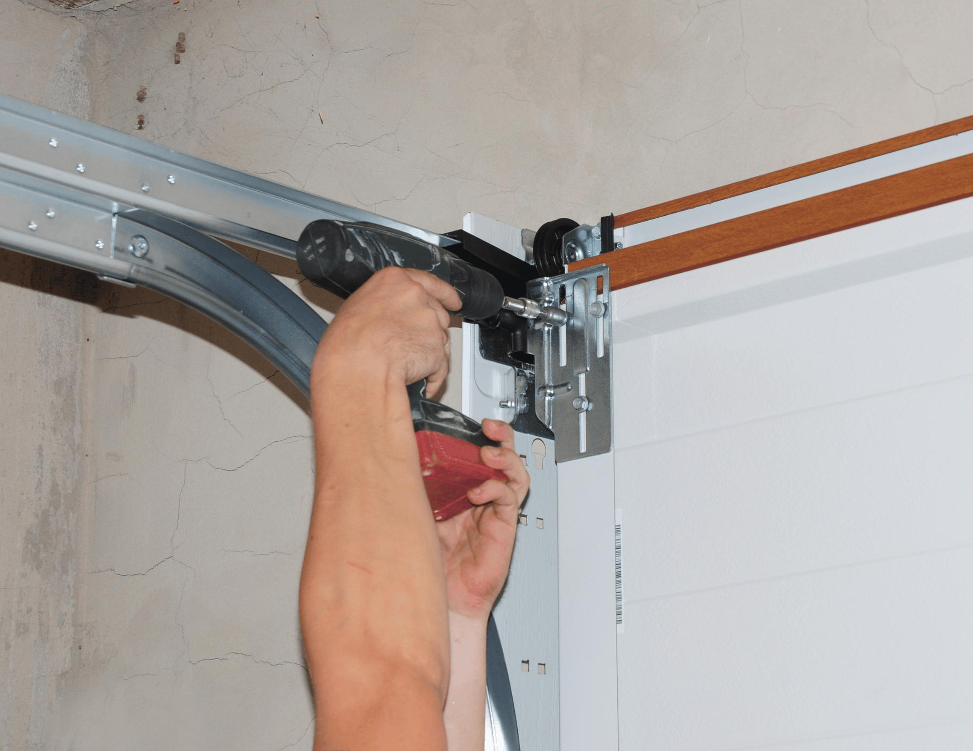 Garage door spring getting fixed. Tips for better garage door maintenance.